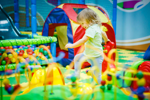 child is playing in the children's room. Children in the entertainment center. Fun in the children's playroom. stock photo