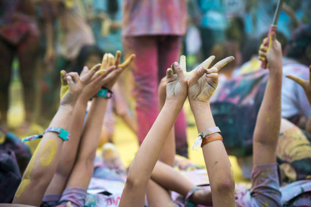 istock Hands raising in the air at color run event 925722080