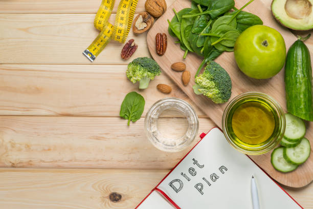 istock Diet plan concept - selection of green food and note pad 925722086