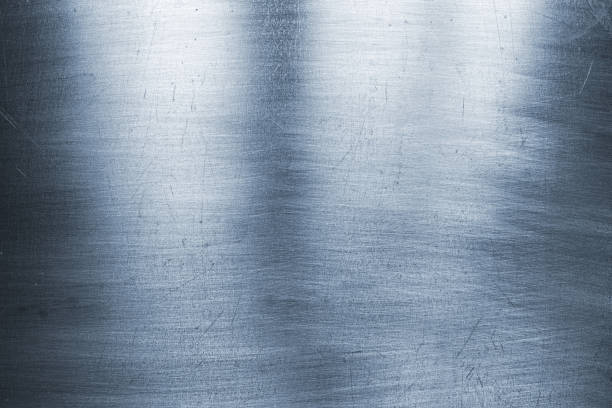 istock bright metal background, polished steel texture with scratches 925726624