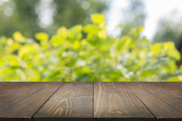 istock Natural bokeh abstract background with wooden board. 925727628