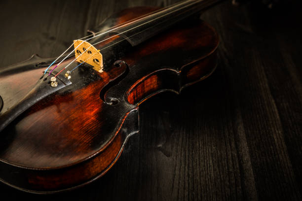 istock Old violin in vintage style on wood background 925733000