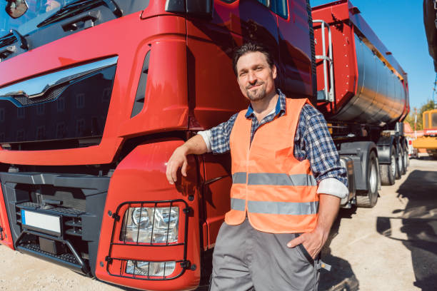 istock Truck driver in front of his freight forward lorry 925733408