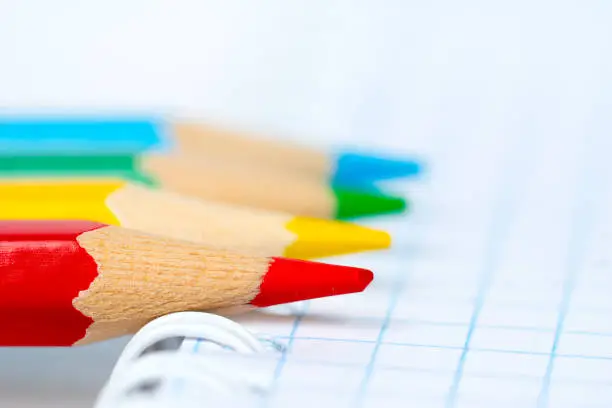 colorful pencil tips on notebook, learning concept