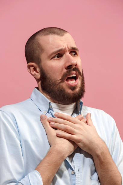 istock Isolated on pink young casual man is boring at studio 925742018