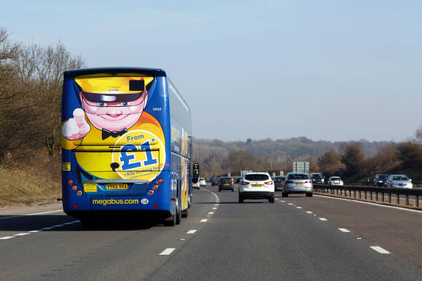 Megabus on the M4 - UK London, UK: February 24, 2018: A Megabus in transit on the M4. Megabus coach service travels to over 90 intercity destinations across the UK with cheap coach tickets from as little as £1. coach bus stock pictures, royalty-free photos & images