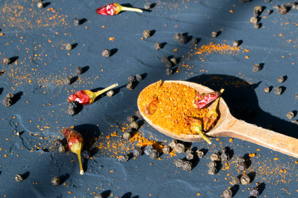 istock Mixture of peppers on a black background 925743166
