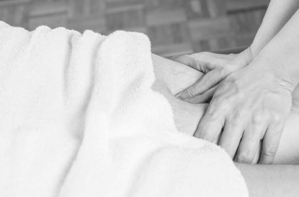 istock physiotherapist doing a hamstrings  massage to man patient. Osteopathy 925745890