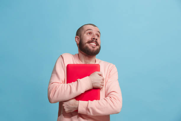 istock Businessman hugging laptop at studio 925749694