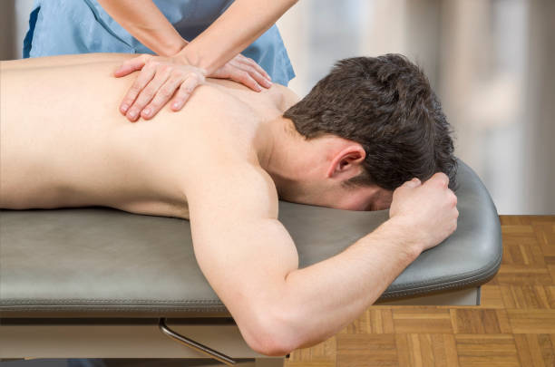 istock Physiotherapist, chiropractor giving a back massage to man patient. Osteopathy. 925752798