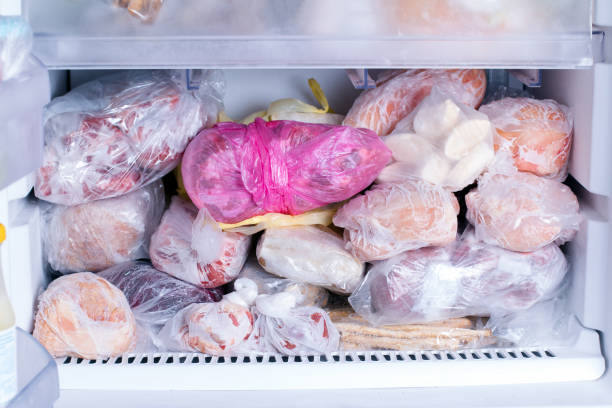 istock Refrigerator with frozen food. Open fridge freezer (meat, milk, vegetables). 925753434