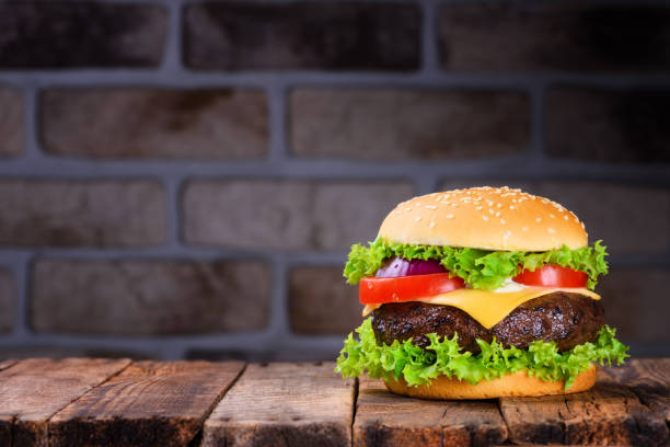 istock Big classic hamburger on wooden table 925757168