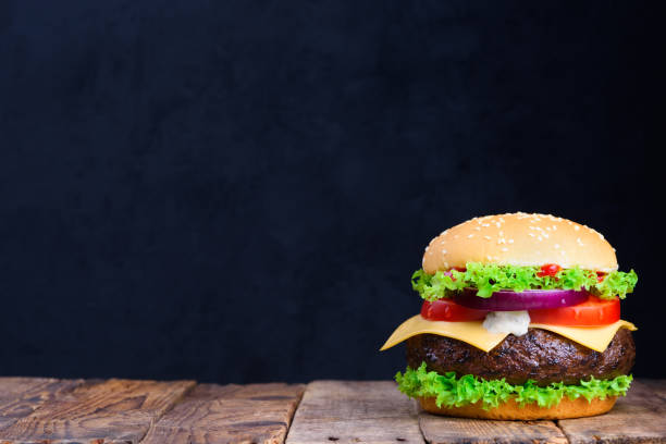 istock Big classic hamburger on wooden table 925757554