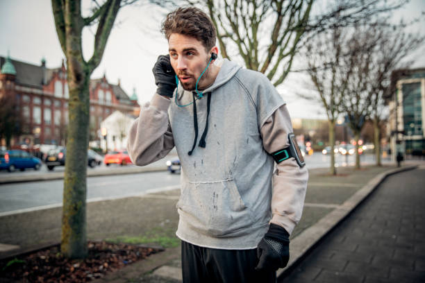 istock Male Runner Adjusting His Earphones 925758070