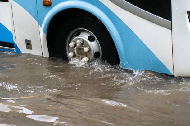 istock Bus splashes through a large puddle on a flooded street 925758540