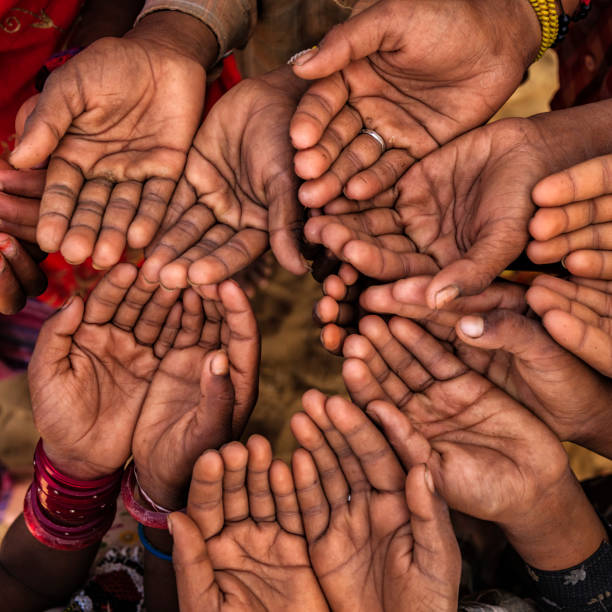 istock Hands of poor - children asking for help, India 925759172