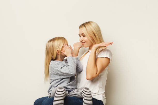 istock Young mother and little daughter clapping hands at white studio background 925763152