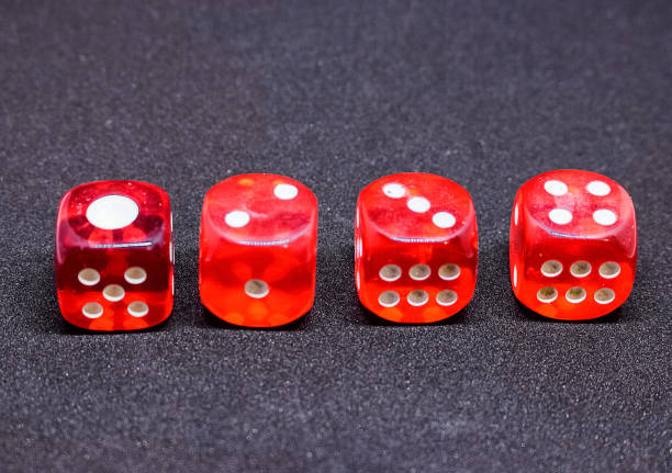 istock Bones for playing poker in red on a dark background.  One to four. 925766054