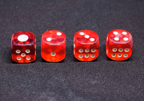 istock Bones for playing poker in red on a dark background.  One to four. 925766074