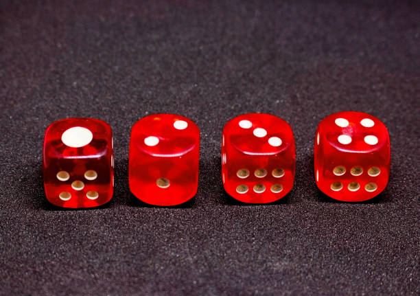 istock Bones for playing poker in red on a dark background.  One to four. 925766112