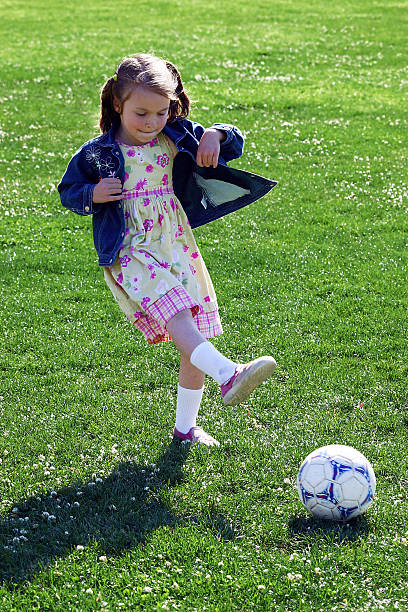 istock Girl Kicking Soccer Ball 92576625