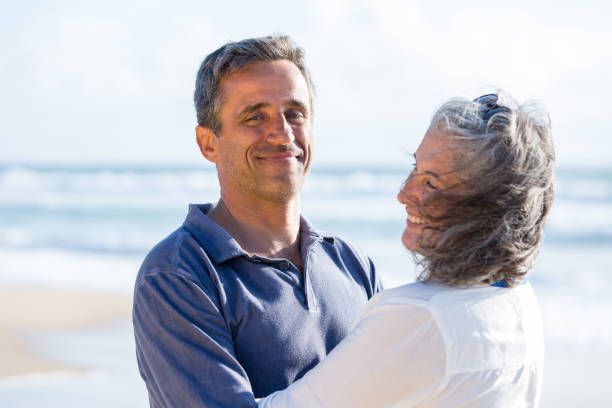 istock happy senior couple walking beach 925771392