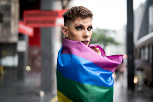 istock Confident Gay Boy Holding Rainbow Flag 925771746