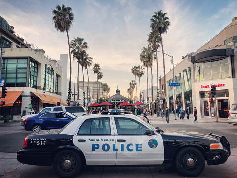 Santa Monica, USA - December 27 , 2017: Third Street Promenade, Santa Monica. Police car is parked. People walking, shopping. Santa Monica Downtown, pedestrian street.