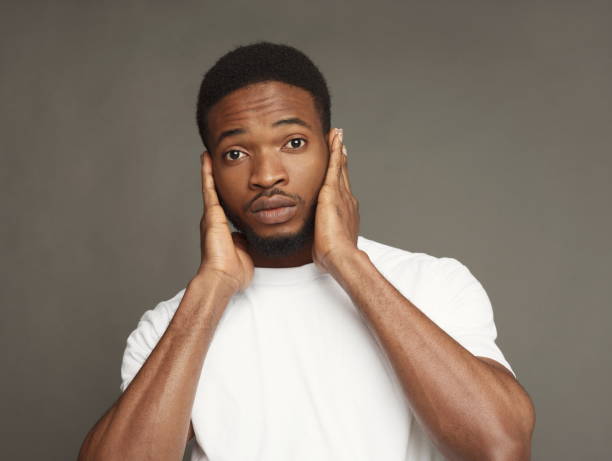istock Black man covering ears with hands 925781814