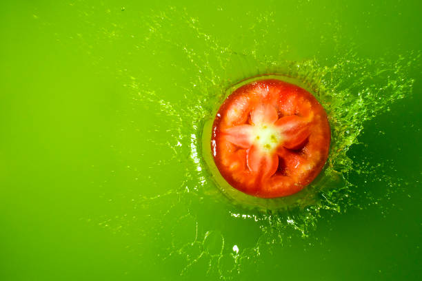 Sliced tomato on green stock photo