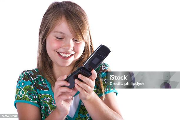 Smiling Girl Dialing Cell Phone Stock Photo - Download Image Now - Beautiful People, Cheerful, Child