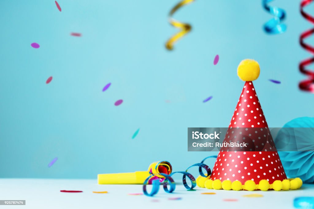 Colorful birthday party hat and streamers Colorful birthday party background with hat and streamers Birthday Stock Photo