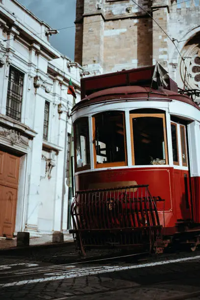 Quaint tram passes directly in front of the Se Cathedral in Lisbon. Lisboa Lissabon.