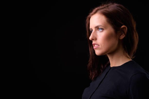 istock Young beautiful woman against black background 925804312