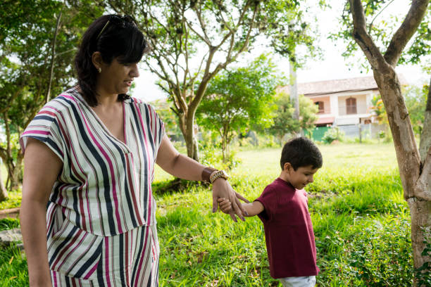 istock Mother and son walking hand in hand 925806870