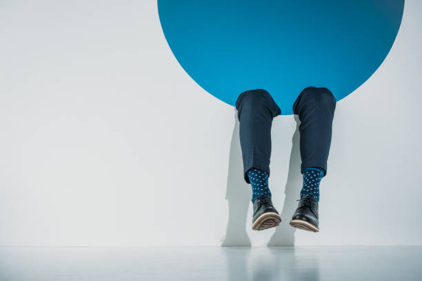 istock low section of stylish young man falling into hole on grey 925814220