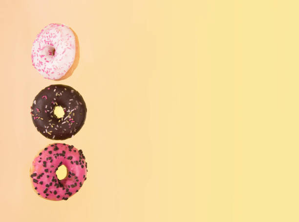 istock Colorful glazed donuts in motion with funny eyes 925819598