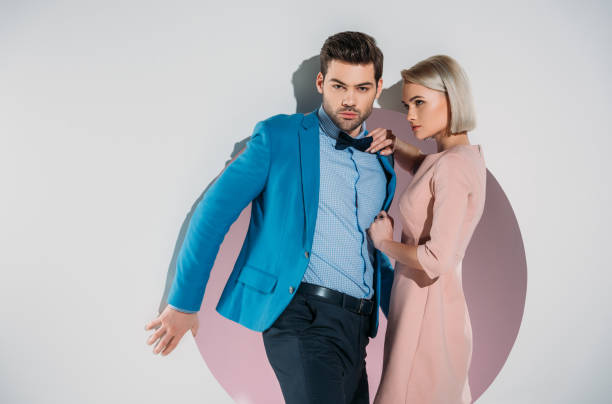 istock fashionable young couple posing together in hole on grey 925820436