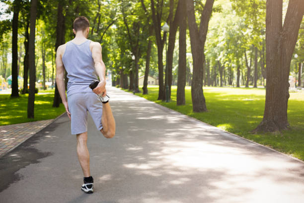 istock Fitness man stretching legs outdoors 925820740