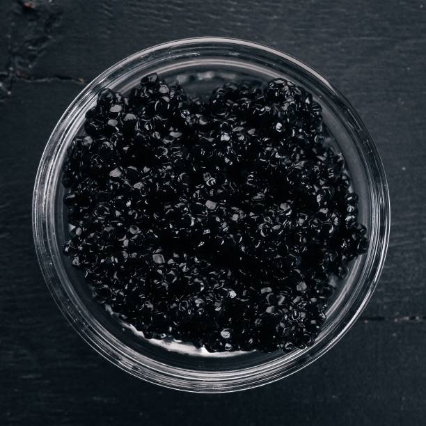istock Black caviar. Sturgeon caviar. On a wooden background. Top view. Free space for text. 925820802