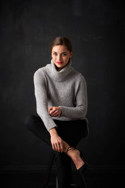 istock Relaxed young woman at dark background 925827856