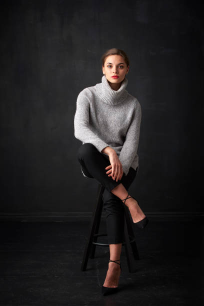 istock Relaxed young woman at dark background 925827860