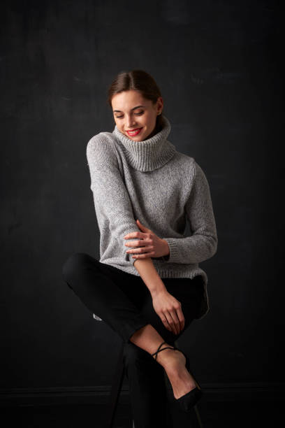 istock Relaxed young woman at dark background 925827866