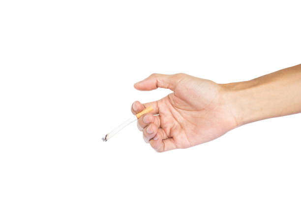 istock Cropped Hand Holding Cigarette Against White Background 925827996