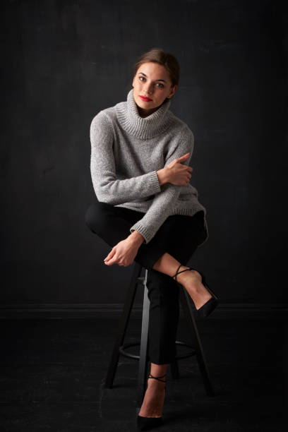 istock Relaxed young woman at dark background 925828198