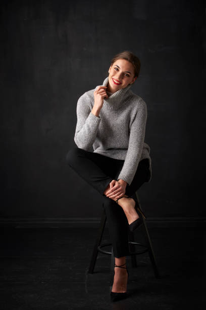 istock Relaxed young woman at dark background 925828204