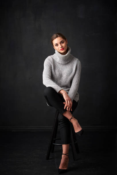 istock Relaxed young woman at dark background 925828222