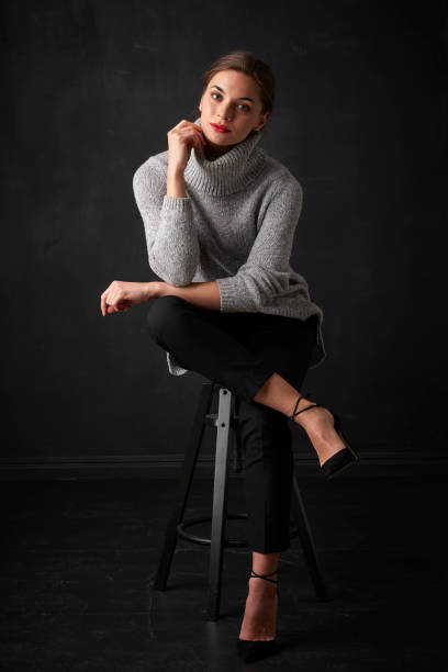 istock Relaxed young woman at dark background 925828226