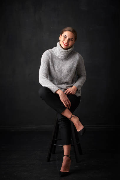 istock Relaxed young woman at dark background 925830366
