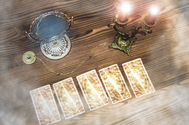 istock Foreteller. Future teller. Tarot cards on wooden table. 925830658